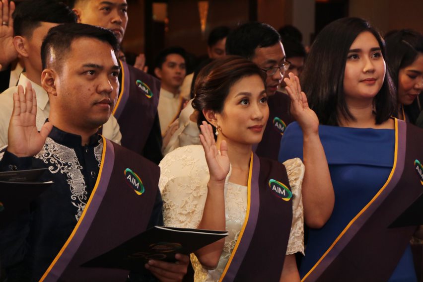 Graduates taking their oaths during their induction to the AIM Alumni Association 