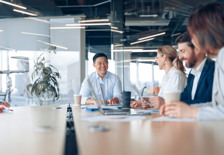Workteam of young asian businessman working and communicating together in an modern office