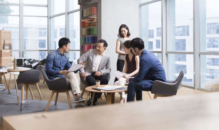 Chinese business people talking in meeting