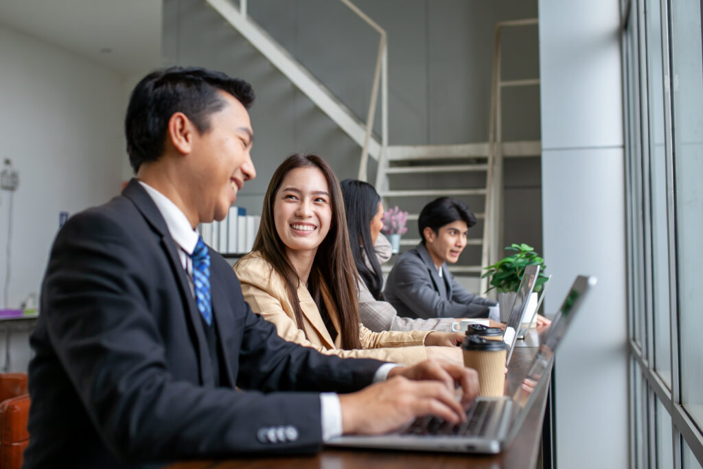 Asian business team male and female colleagues talking at work s