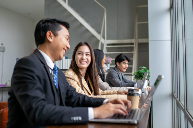 Asian business team male and female colleagues talking at work s
