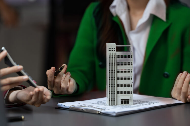 Asian businesswoman making a deal to buy a house or condo inside