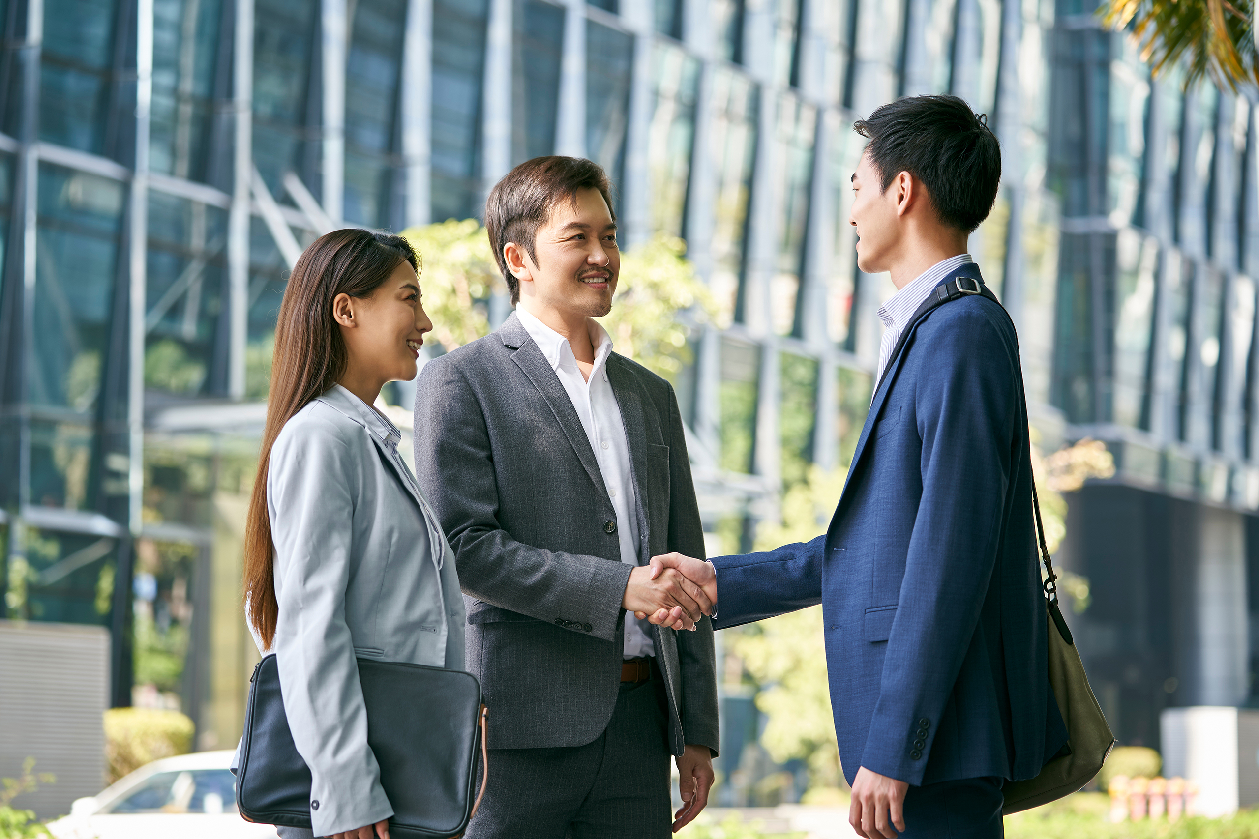 Asian,Business,Associates,Meeting,In,The,Street,In,Downtown,Financial