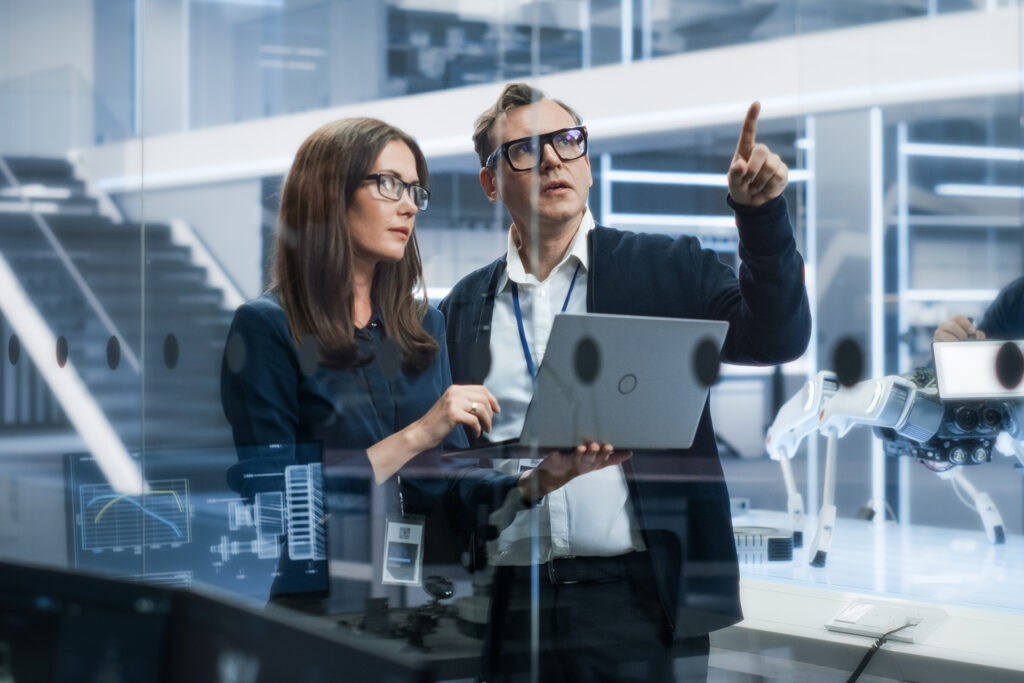 Portrait,Of,Two,Young,Female,And,Male,Engineers,Use,Laptop