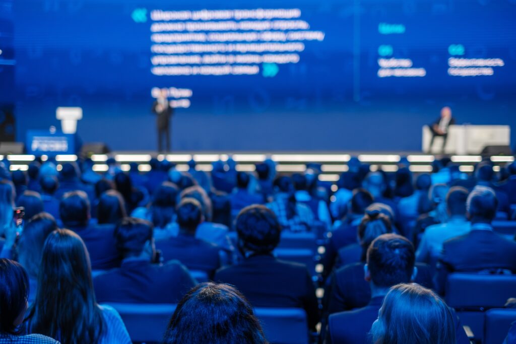 a presenter talking to a panel discussion