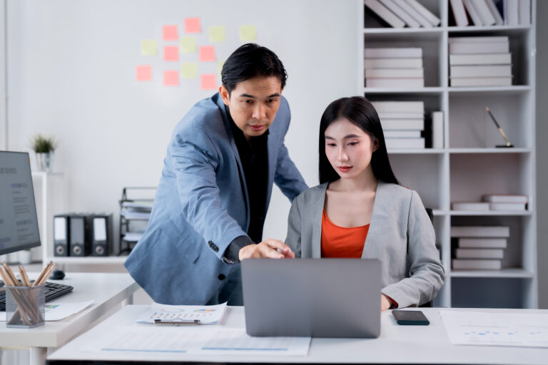 Two,Asian,Business,People,Discussing,And,Working,Together,Using,Laptop