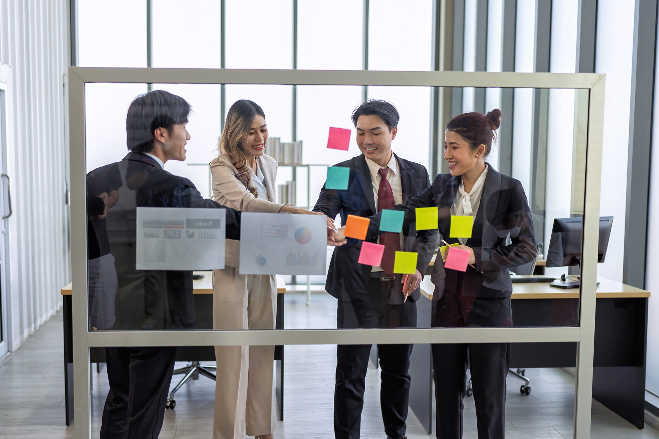 Employee meeting at office and use post it notes to share idea b