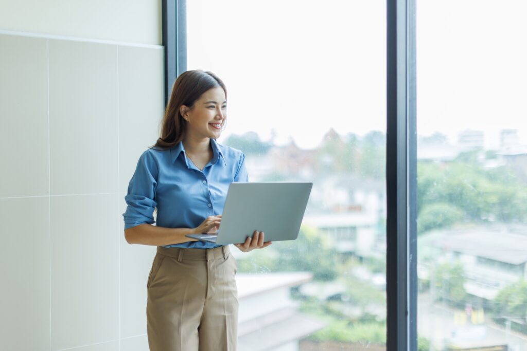 a data science student holding a laptop