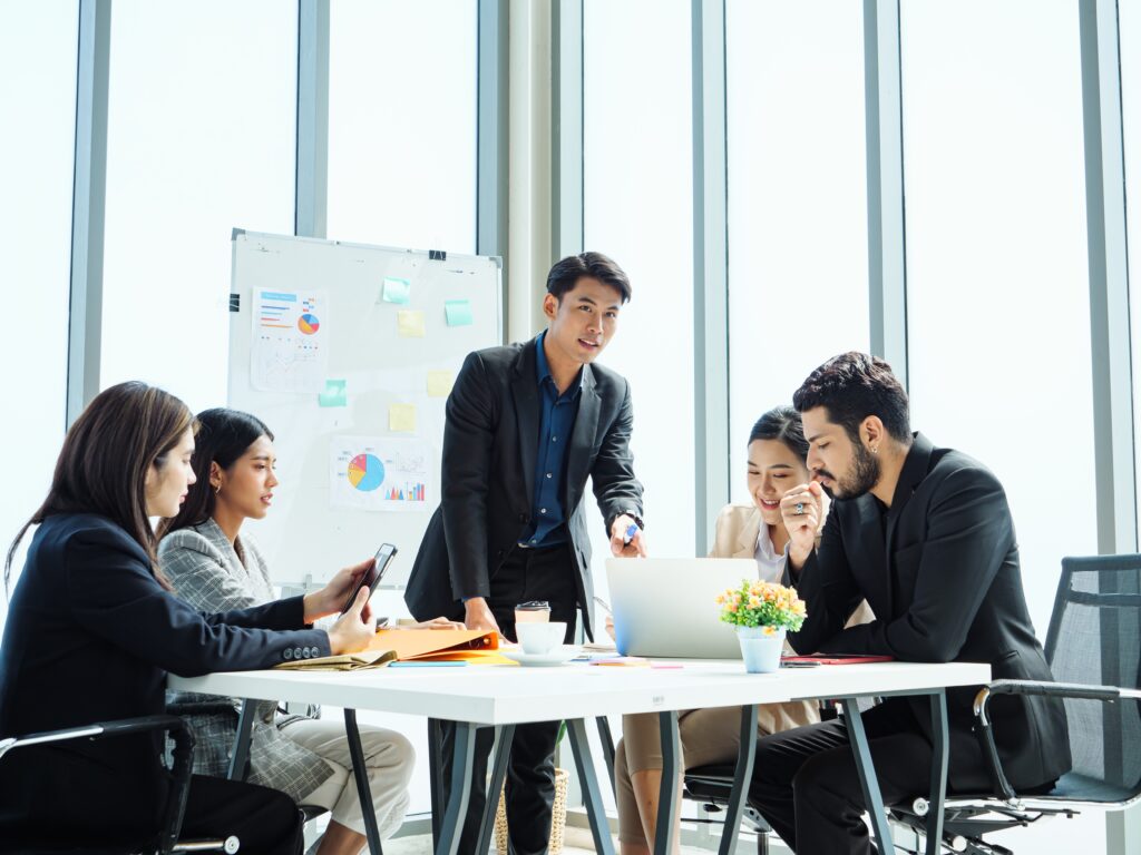 Asian,Business,Team,In,Modern,Office,Meeting,,Male,Leader,Presenting