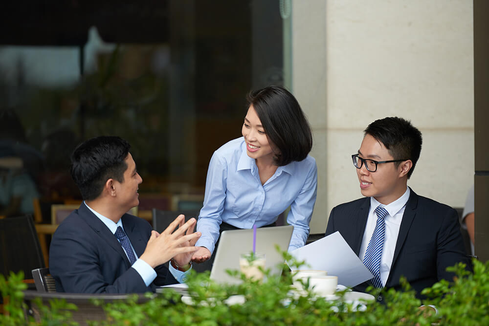 Executive MBA participants working together on a business strategy discussion during a hybrid learning session.