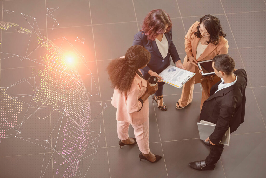 Diverse group of business professionals discussing strategy, representing the collaborative learning experience of an international MBA program.
