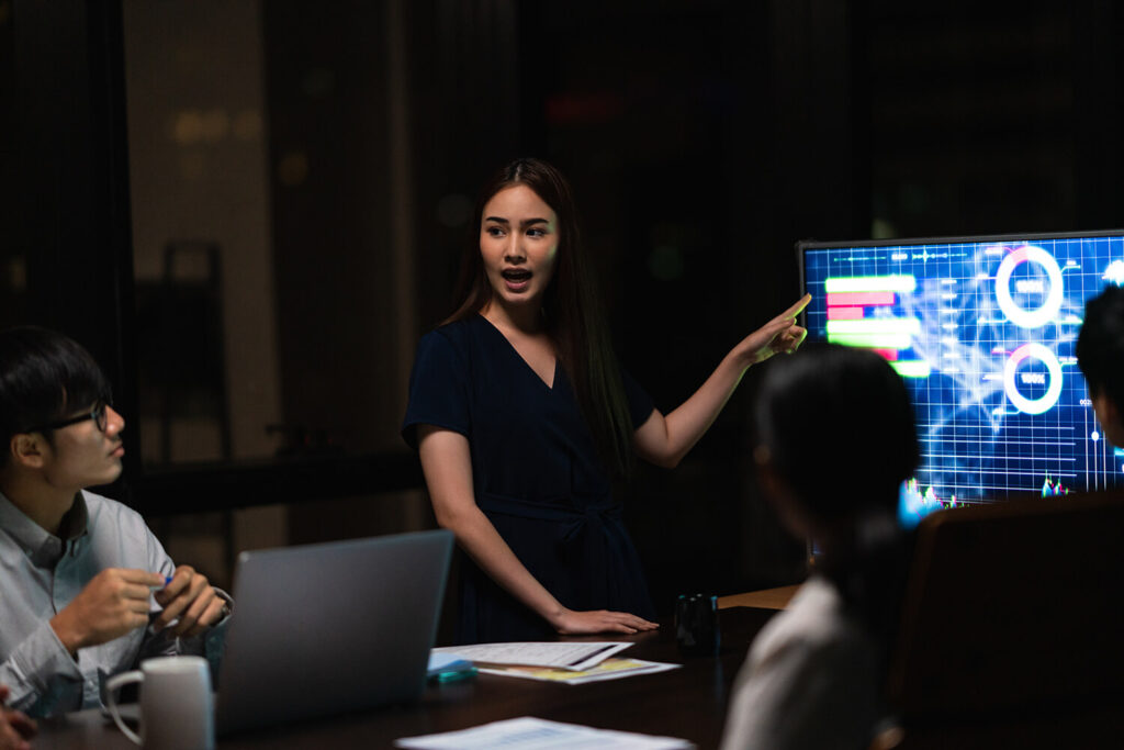 Executives discussing AI-driven business strategy and digital transformation during a leadership presentation, reflecting the AIM EMBA curriculum's focus on technology and executive decision-making.