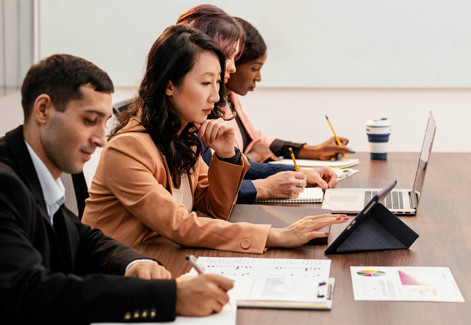 International MBA cohort reviewing business data and case materials during a strategy session, representing the analytical rigor of a 12-month MBA in Asia.