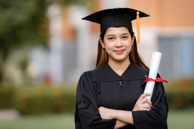 A woman wearing a graduation robe and holding a diploma.